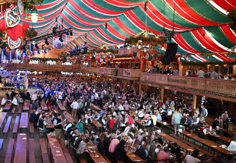 Visitors at the opening of the Cannstatter Wasen folk festival. Organizers of the world-famous Oktoberfest in Munich will not allow the song "L'Amour Toujours" to be played at the beer festival after a series of incidents where crowds in Germany shouted far-right chants to the melody of the decades-old pop tune. Bernd Weißbrod/dpa