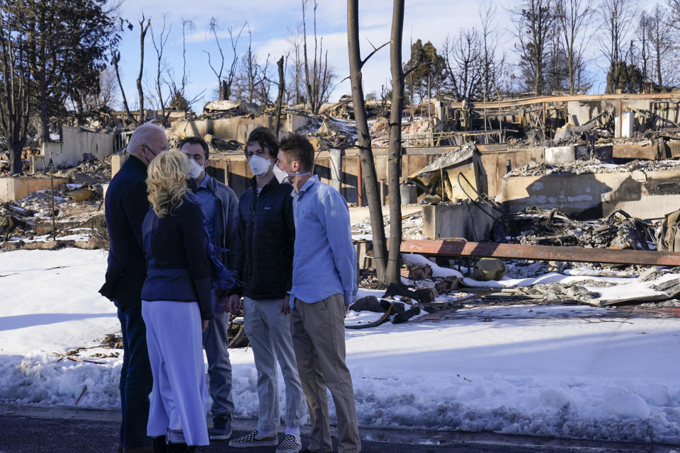 President Joe Biden and first lady Jill Biden talk with people as they tour a neighborhood in Louisville, Colo., Friday, Jan. 7, 2022, that was impacted by the recent wildfire. (AP Photo/Susan Walsh)