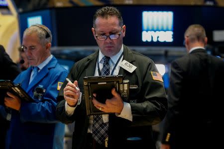 Traders work on the floor of the New York Stock Exchange (NYSE) in New York, U.S., October 20, 2017. REUTERS/Brendan McDermid