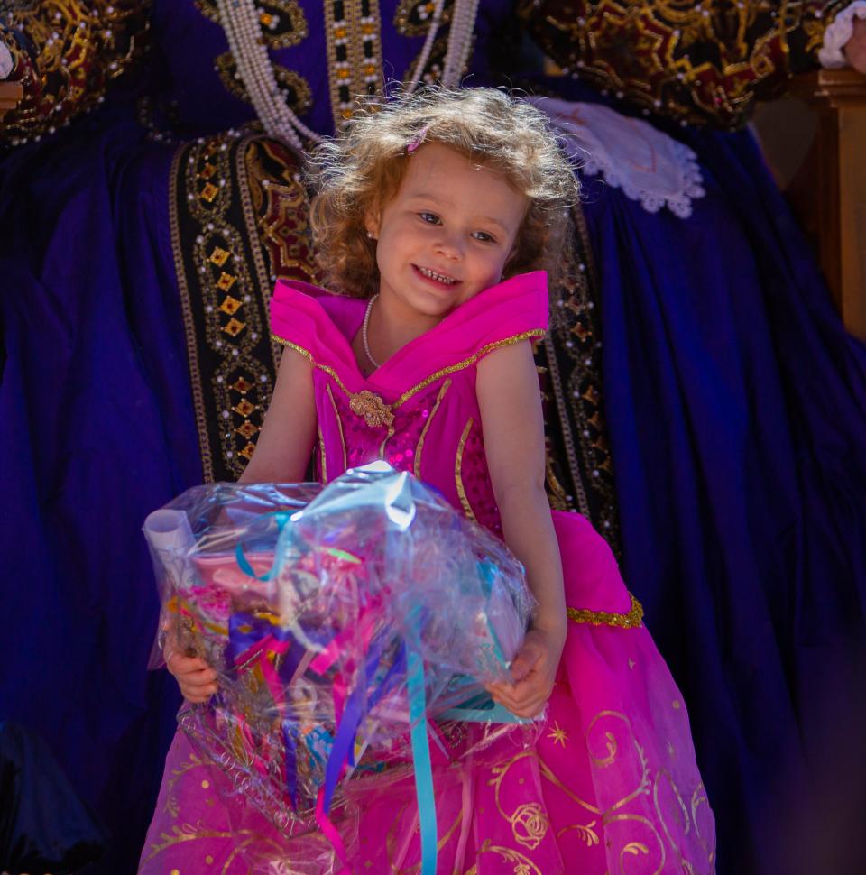 Nina Evinger poses for a picture with her prize after the Princess contest at the Renaissance Festival in Gold Canyon on Feb. 18, 2023.