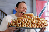 <p>Current men’s champion Joey Chestnut, of San Jose, CA., holds a tray of hot dogs during the weigh-in for the 2017 Nathan’s Hot Dog Eating Contest, in Brooklyn Borough Hall, in New York, Monday, July 3, 2017. Chestnut weighed-in at 221.5 pounds. (AP Photo/Richard Drew) </p>