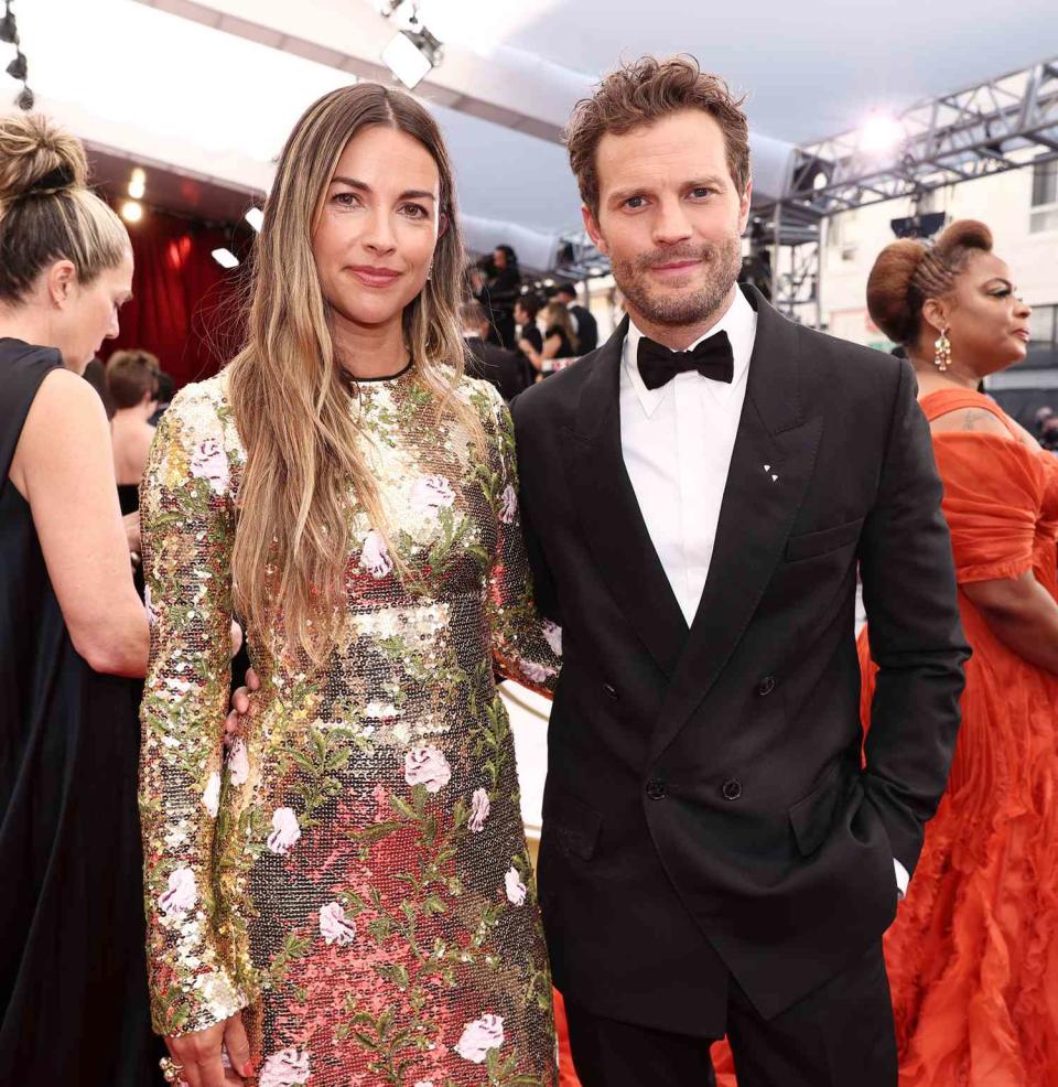 Amelia Warner and Jamie Dornan attend the 94th Annual Academy Awards at Hollywood and Highland on March 27, 2022 in Hollywood, California