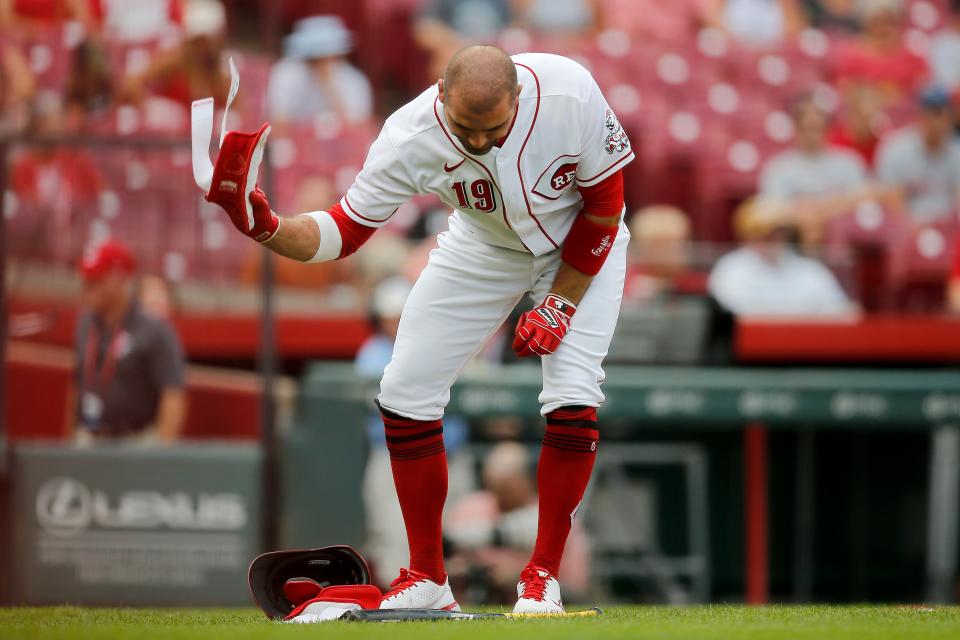 Cincinnati Reds first baseman Joey Votto (19) slams his gear on the ground after striking out in the first inning of the MLB National League game between the Cincinnati Reds and the Miami Marlins at Great American Ball Park in downtown Cincinnati on Tuesday, July 26, 2022.