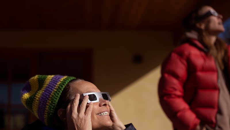 Jill Baillie and Courtney Henley watch an annular solar eclipse in Torrey, Utah, on Saturday, Oct. 14, 2023. A phenomenon known as the "ring of fire" was visible because of the way the sun's edges perfectly surround the moon.