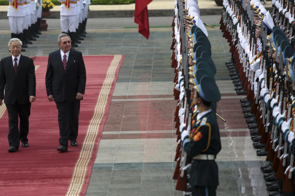 Cuban President Raul Castro, second left, and Vietnamese General Secretary of Communist Party, Nguyen Phu Trong, left, review the guards of honor at the welcome ceremony in Hanoi, Vietnam on Sunday, July 8, 2012. (AP Photo/Na Son Nguyen)