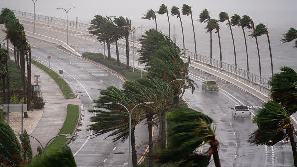 Motorists travel across the John Ringling Causeway as Hurricane Ian churns to the south on September 28, 2022, in Sarasota, Florida.