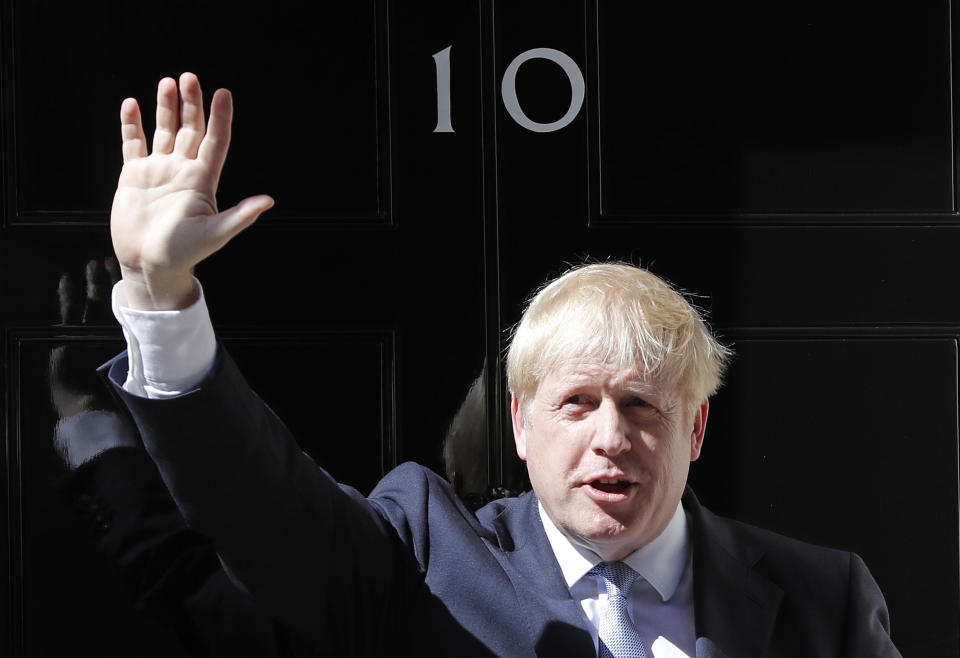 FILE - In this file photo dated Wednesday, July 24, 2019, Britain's Prime Minister Boris Johnson waves from the steps outside 10 Downing Street in London. In a letter released Wednesday Aug. 28, 2019, Prime Minister Johnson has written to fellow lawmakers explaining his decision to ask Queen Elizabeth II to suspend Parliament as part of the government plans before the Brexit split from Europe. (AP Photo/Frank Augstein, FILE)