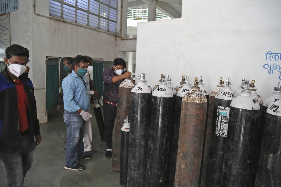 Hospital staff checks oxygen cylinders after a leakage in a oxygen plant in Nashik, in the Indian state of Maharashtra, Wednesday, April 21, 2021. A local administrator in western India says 22 patients have died in a hospital when their oxygen supply was interrupted by a leakage in a supply tank. The official says the oxygen supply has since been resumed to other patients. (AP Photo)