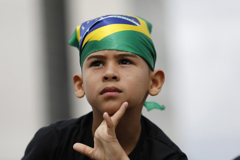 A child waits for the swearing-in ceremony of Brazil's new President Jair Bolsonaro, in front of the Planalto palace in Brasilia, Brazil, Tuesday Jan. 1, 2019. (AP Photo/Silvia Izquierdo)