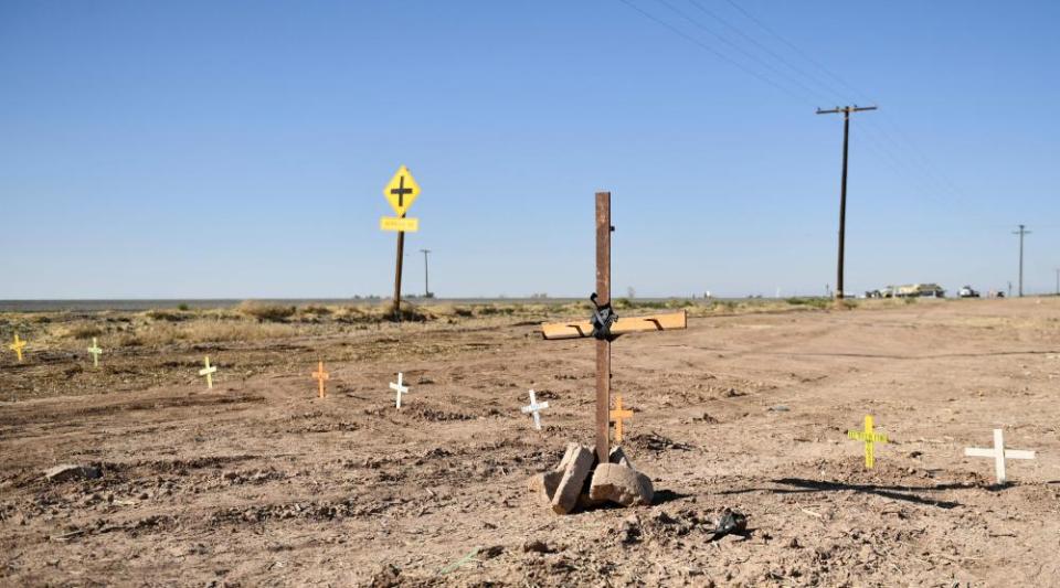 Crosses are seen near the scene of a crash between an SUV and a tractor-trailer.