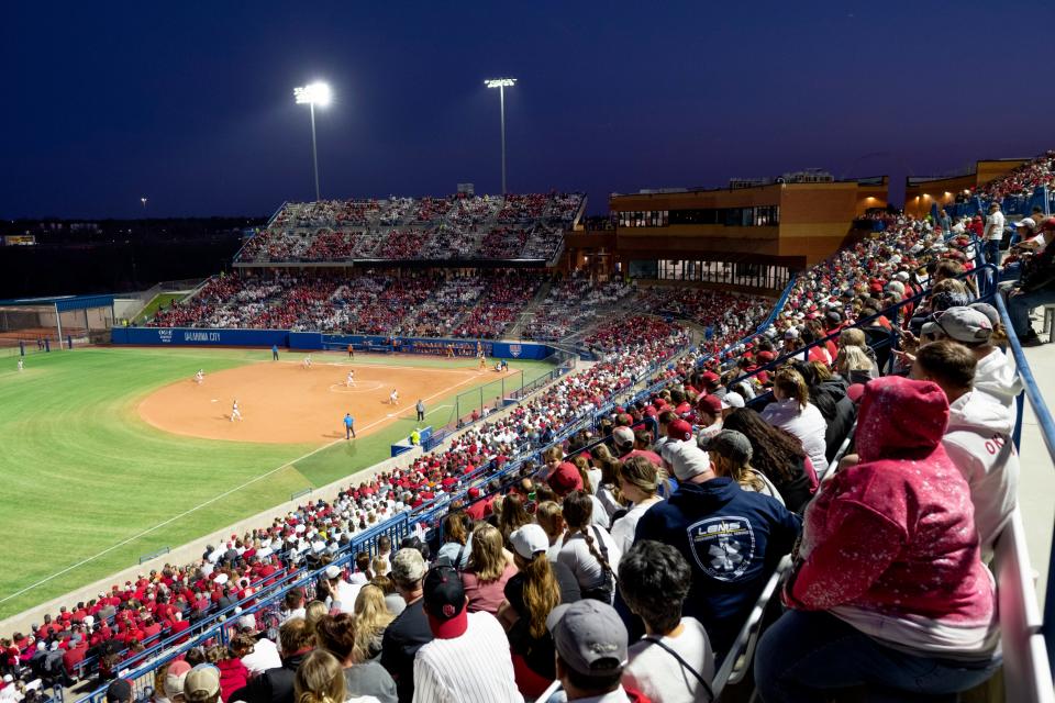 Fans watch during a college softball game between the University of Oklahoma Sooners (OU) and the Texas Longhorns at USA Hall of Fame Stadium in Oklahoma City, Friday, March 31, 2023. 