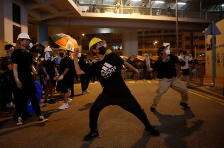 An anti-extradition demonstrator throws an egg at a police station, after a march to call for democratic reforms in Hong Kong