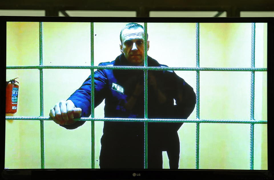 Russian opposition leader Alexey Navalny is seen on a screen via video link from the IK-2 corrective penal colony in Pokrov, Russia, before a court hearing to consider an appeal against his prison sentence in Moscow, May 17, 2022. / Credit: EVGENIA NOVOZHENINA/REUTERS