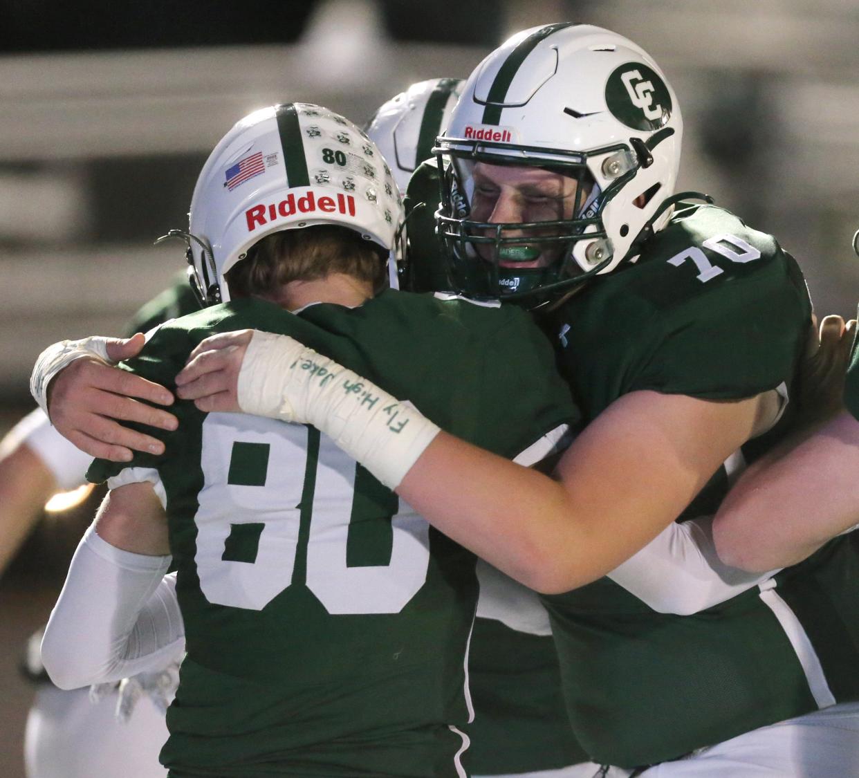 Jack Hopkins, left of Central Catholic celebrates his touchdown with Jonathan Stangl, right, during their game against St. Thomas at Central Catholic on Thursday, Oct. 20, 2022. Stangl honored Jacob Brown by writing, "Fly High Jake" on his taped arm. Brown lost his life in an automobile accident Sunday. 