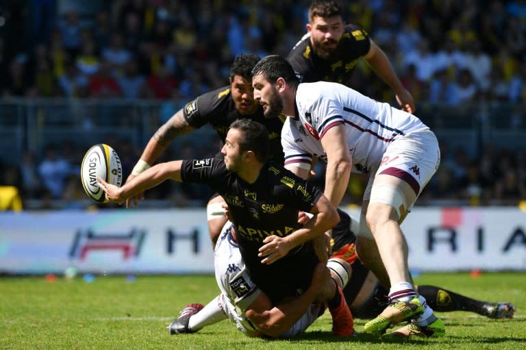 La Rochelle's Alexis Bales (L) passes the ball during their French Top 14 rugby union match against Bordeaux-Begles on April 08, 2017 in La Rochelle, southwestern France