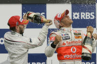 FILE - In this Sunday, June 10, 2007 file photo, Sauber driver Nick Heidfeld, left, of Germany, and McLaren Mercedes driver Lewis Hamilton, right, of Britain, celebrate after Hamilton won the Canadian Grand Prix Formula One race at the Circuit Gilles Villeneuve in Montreal, Canada. British driver Lewis Hamilton made Formula One history on Sunday, Oct. 25, 2020 winning the Portuguese Grand Prix for a 92nd win to move one ahead of German great Michael Schumacher. (AP Photo/Darron Cummings, file)