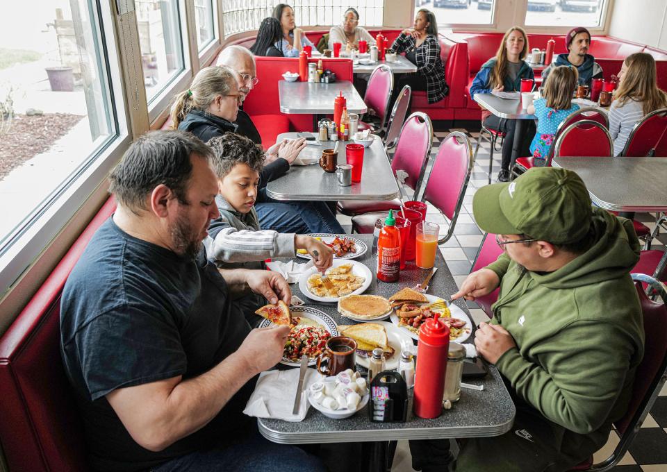 Longtime regulars at Fleetwood Diner in Lansing, Daniel Ceballos, left, Blas Dehuelbes Jr. and his dad Blas Dehuelbes enjoy brunch Sunday, May 1, 2022. The senior Dehuelbes makes a point to say they get the No. 2 special and the hippie hash all the time and added the fresh-squeezed orange juice is the best in town.