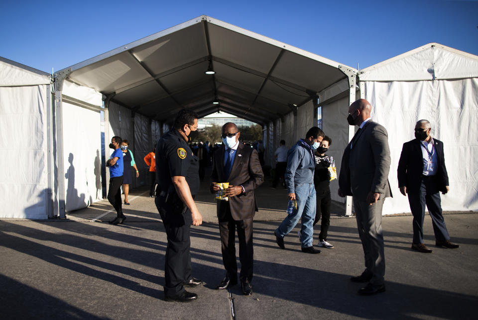 Houston Police Department Chief Art Acevedo and Houston Mayor Sylvester Turner talk by the new federally-supported and state-managed COVID-19 vaccination clinic tents at NRG Park, Monday, Feb. 22, 2021, in Houston. (Marie D. De Jesus/Houston Chronicle via AP)