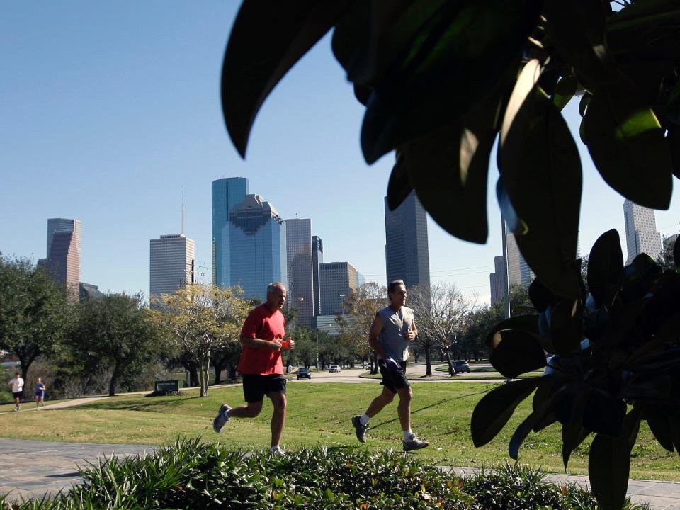 Joggers run near downtown Houston.