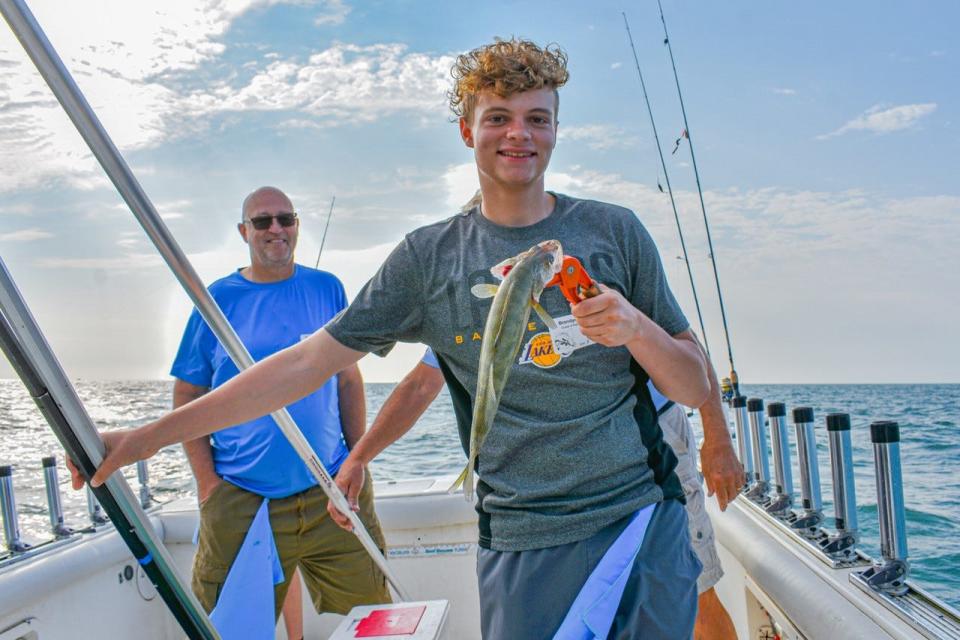 Brendyn Ash, right, caught the first keeper fish on the Seabreeze Charters boat captained by Ron Eickholt. Ash was a guest of State Rep. Gary Click, left. Also on the boat were Division of Wildlife District Two Manager, Scott Butterworth and Brendyn’s brother, Thomas Ash.