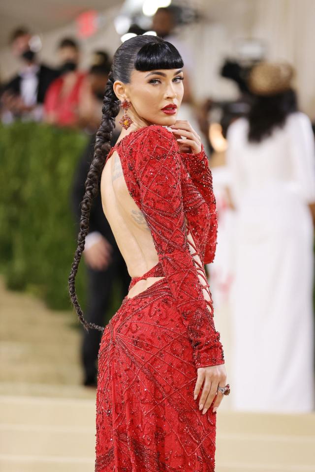 Megan Fox stole the show at the Met Gala in a red gown with crisscross cutouts and a thigh-high slit