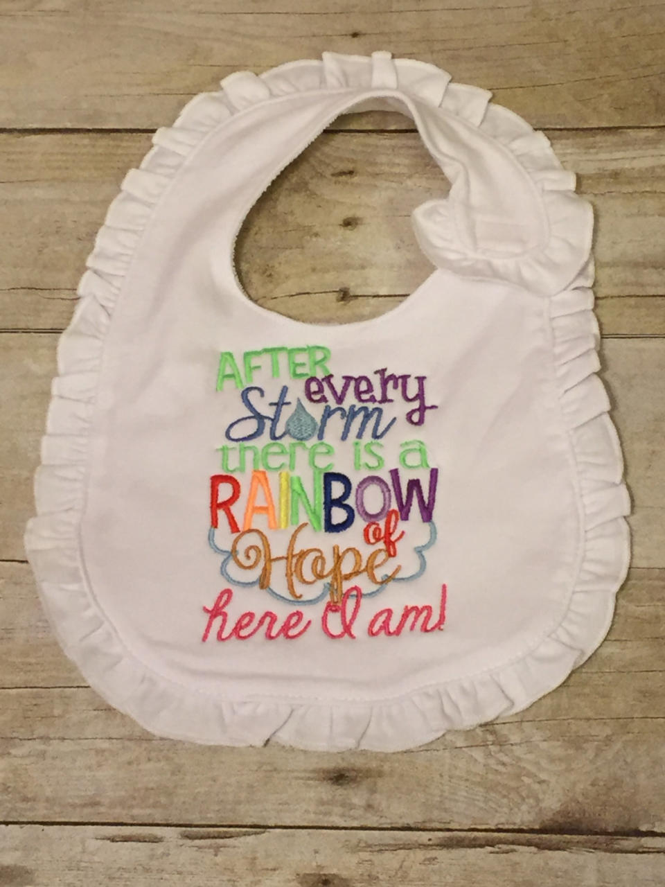 $15.95, <a href="https://www.etsy.com/listing/453813788/rainbow-baby-bib-for-girl-or-boy-after" target="_blank">MomMomsPlace</a>