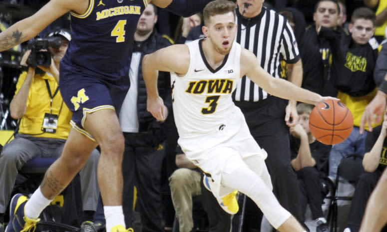 Iowa's Jordan Bohannon dribbles past Michigan's Isaiah Livers.