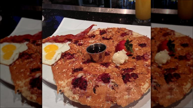 Hash House A Go Go huge pancake with eggs and bacon