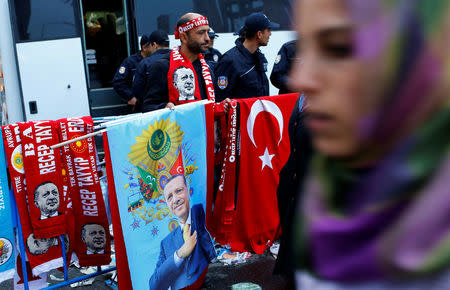 A street vendor sells flags and scarves with portraits of Turkish President Tayyip Erdogan during a rally for the upcoming referendum in the Kurdish-dominated southeastern city of Diyarbakir, Turkey, April 1, 2017. REUTERS/Murad Sezer