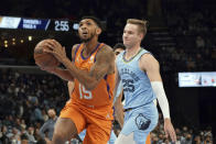 Phoenix Suns' Cameron Payne (15) goes up for a basket as Grizzlies Mikal Bridges (25) defends in the second half of an NBA basketball game Friday, Nov. 12, 2021, in Memphis, Tenn. (AP Photo/Karen Pulfer Focht)