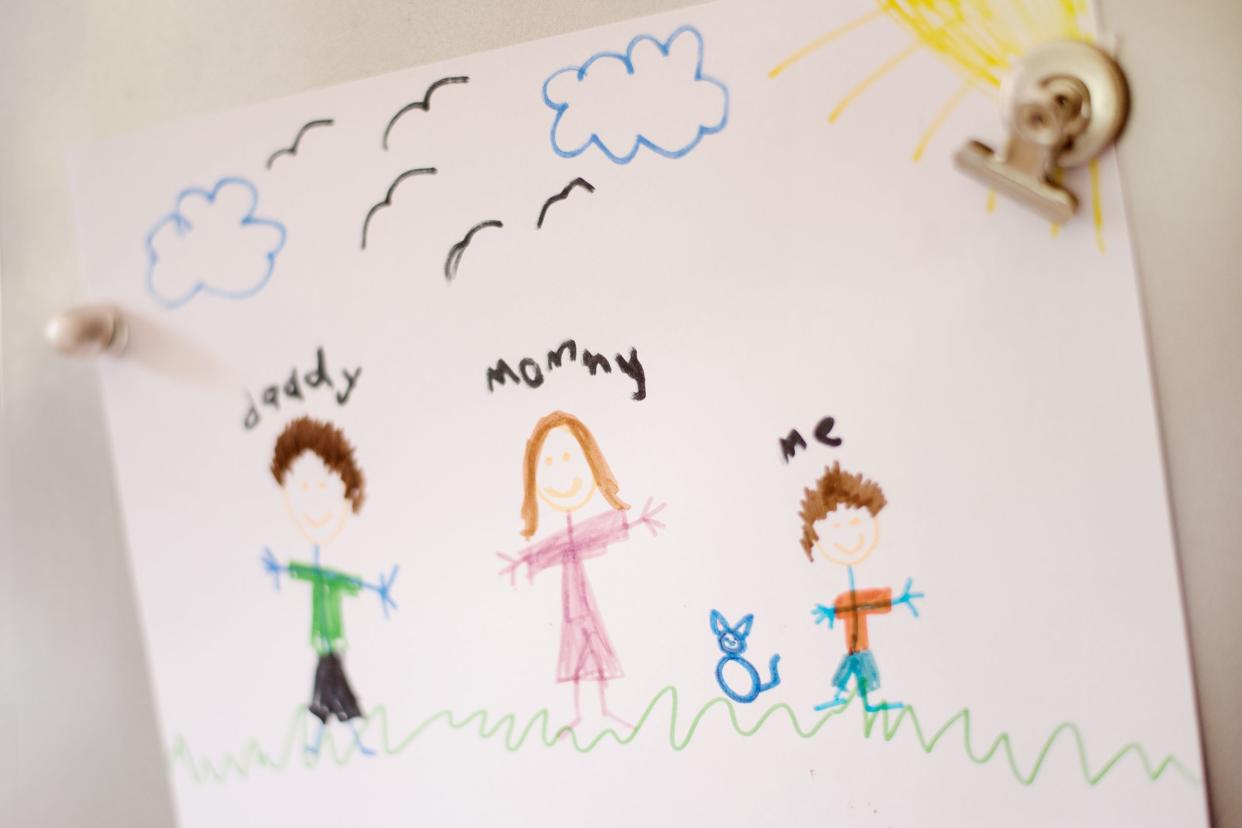 child's art of family on the refrigerator