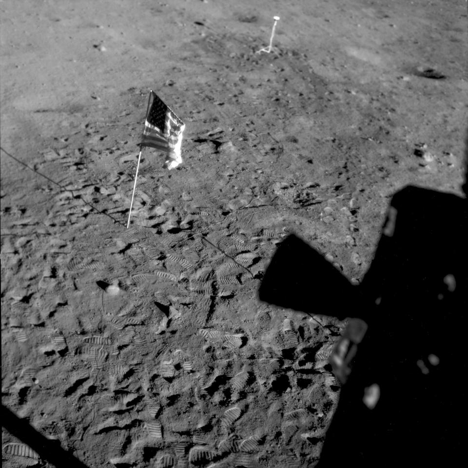 This July 21, 1969 photo made available by NASA shows the U.S. flag planted at Tranquility Base on the surface of the moon, and a silhouette of a thruster at right, seen from a window in the Lunar Module. Rather than let the flag droop, NASA decided to use a right-angled rod to keep it spread out, according to Roger Launius, NASA’s former chief historian. Also, Armstrong and Aldrin were worried that the flagpole was going to fall down after they had twisted it into the ground, so they quickly snapped the photos posing next to it, capturing the flag while it was still moving, Launius said. (NASA via AP)