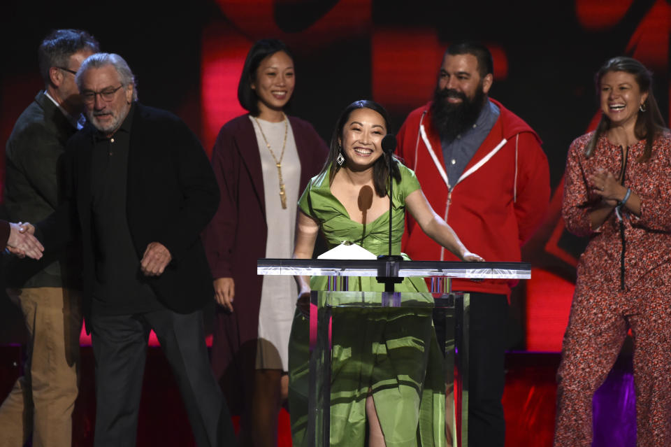 Lulu Wang, center, accepts the award for best feature for "The Farewell" at the 35th Film Independent Spirit Awards on Saturday, Feb. 8, 2020, in Santa Monica, Calif. Robert De Niro, from left, Anita Gou, Andrew Miano, and Daniele Melia look on. (AP Photo/Chris Pizzello)