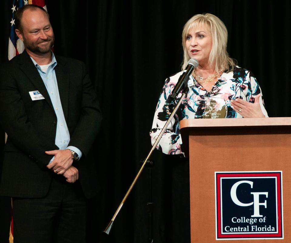 United Way of Marion County Board Chair Greg Harrell listens as County Commissioner Michelle Stone spoke after the commission received the Changemaker of the Year Award Thursday afternoon at the College of Central Florida Klein Center.