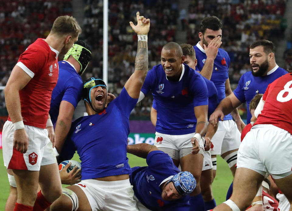 France's Sebastien Vahaamahina, center left, celebrates with teammates after scoring a try against Wales during the Rugby World Cup quarterfinal match at Oita Stadium in Oita, Japan, Sunday, Oct. 20, 2019. (AP Photo/Christophe Ena)