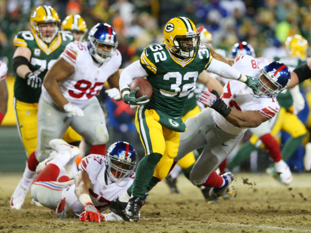 Christine Michael of the Green Bay Packers fends off a tackle