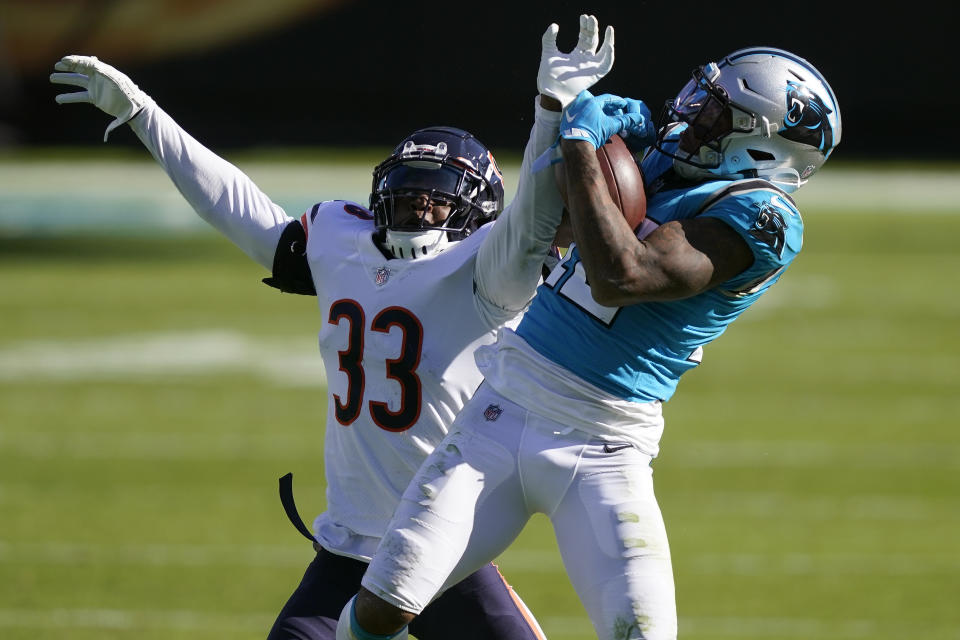 Carolina Panthers wide receiver D.J. Moore catches a pass while Chicago Bears cornerback Jaylon Johnson (33) defends during the second half of an NFL football game in Charlotte, N.C., Sunday, Oct. 18, 2020. (AP Photo/Brian Blanco)