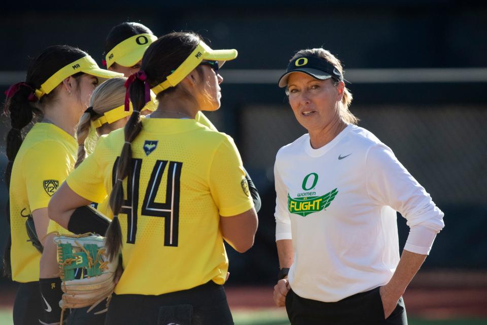 Oregon head coach Melyssa Lombardi talks to her players as the Oregon Ducks host No. 15 California Friday, March 8, 2024, at Jane Sanders Stadium in Eugene, Ore.