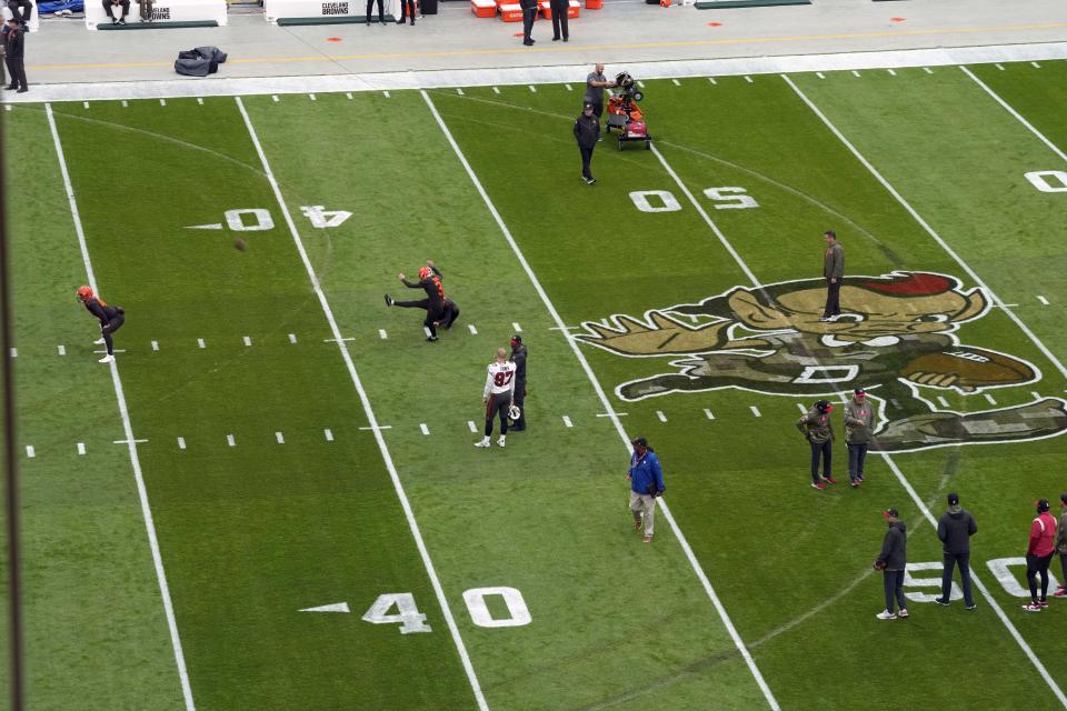 Remnants of tire tracks made by a person who broke into First Energy Stadium earlier this week and drove a vehicle around the field, can be seen during team warm ups before an NFL football game between the Cleveland Browns and the Tampa Bay Buccaneers in Cleveland, Sunday, Nov. 27, 2022. (AP Photo/Gene J. Puskar)