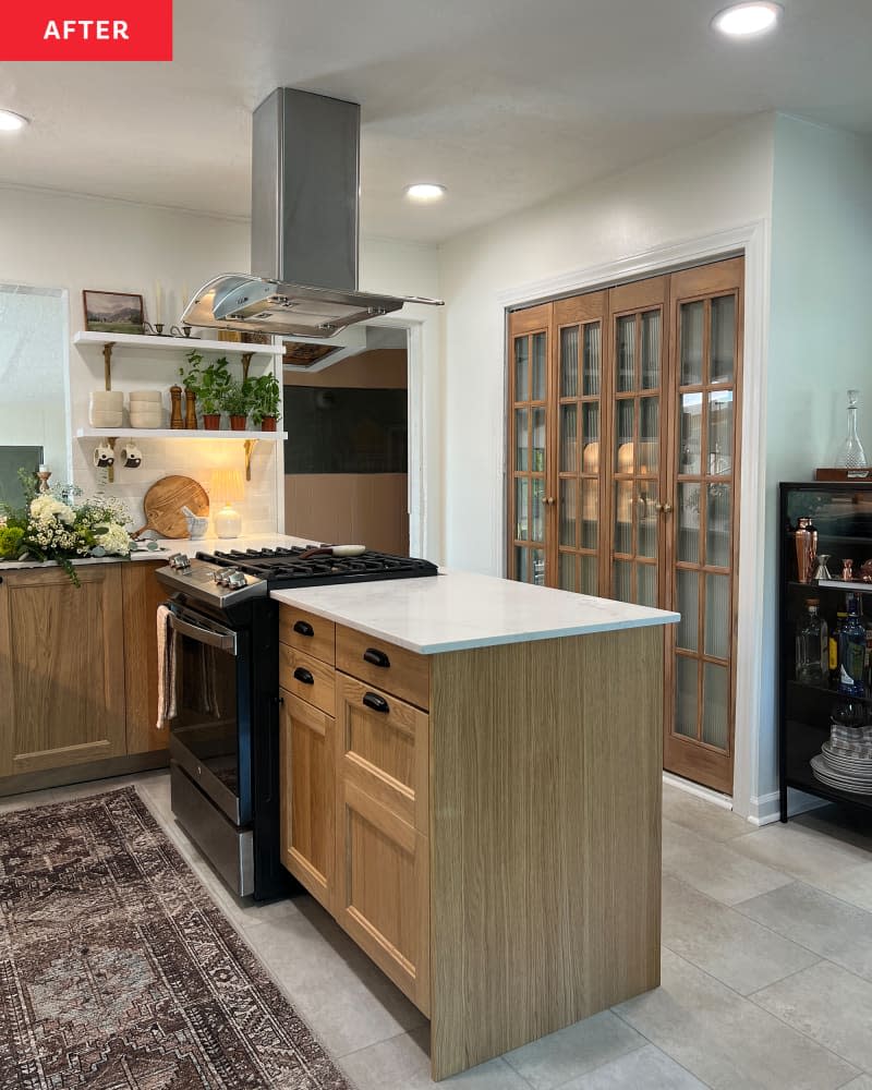 white kitchen with white brick tile backsplash, wood island, and white marble countertops after remodel