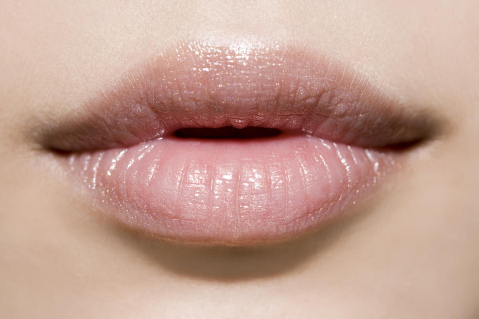 Women are gluing their top lips in a bid to achieve a plumper pout [Photo: Getty]