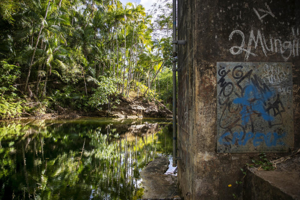 A swimming hole where dozens say they were sexually assaulted when they were boys by Father Louis Brouillard, is seen on the Lonfit River in Ordot, Guam, Monday, May 6, 2019. In his three decades on the island, Brouillard appears to have been Guam's most frequent abuser, with at least 124 accusers. Brouillard volunteered as a swimming instructor, filming boys nude and sexually assaulting them at the jungle swimming hole. Brouillard has acknowledged abuse allegations and is now dead. (AP Photo/David Goldman)