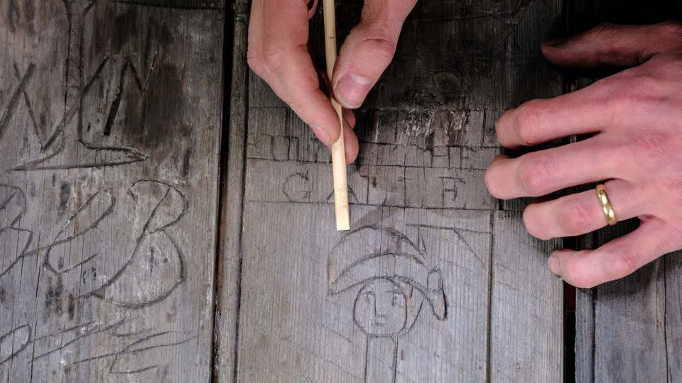 One etching on the door shows a man wearing a military uniform and a bicorne hat being hanged. Historians suggest that this could be a depiction of the French emperor Napoleon Bonaparte. - Jim Holden/English Heritage