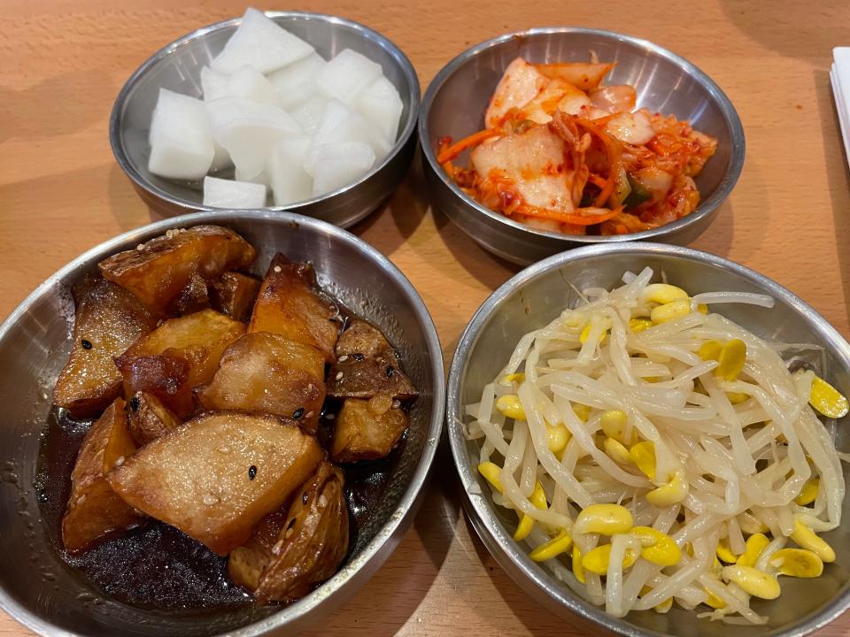 Gogi Korean Kitchen offers a selection of small appetizers, including Korean potatoes in teriyaki sauce, kimchi (pickled cabbage), pickled radishes and bean sprouts.