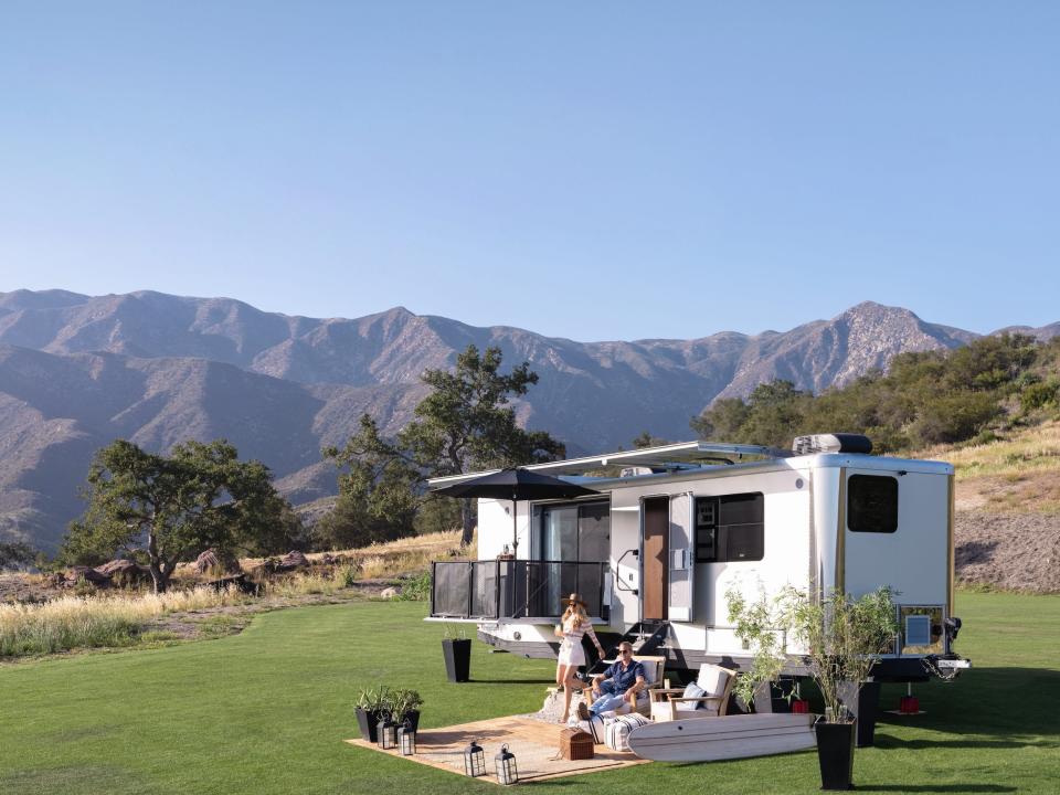 the 2022 Living Vehicle trailer outside on a patch of grass with an outdoor setup