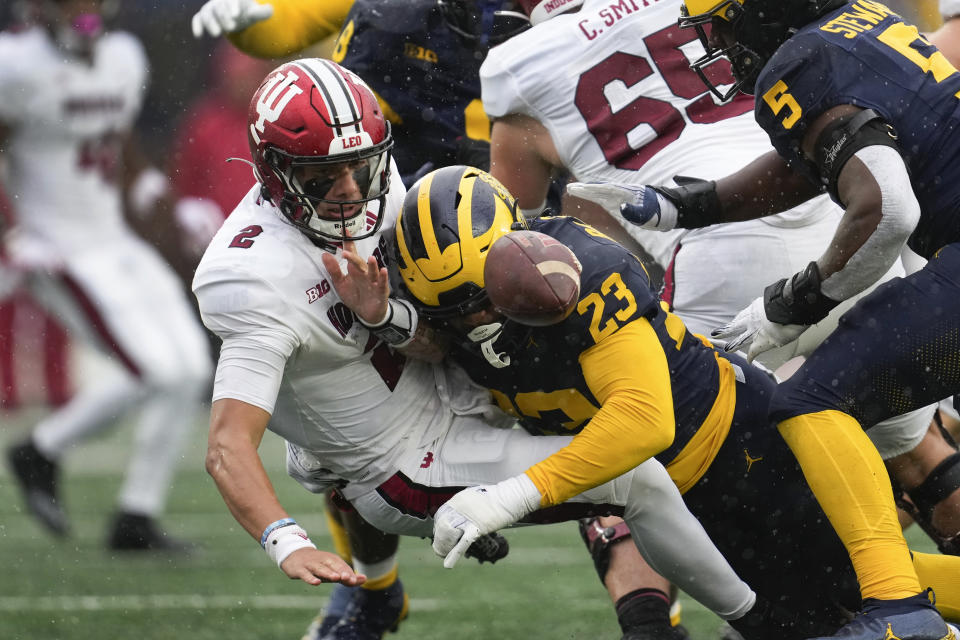 Michigan linebacker Michael Barrett (23) causes Indiana quarterback Tayven Jackson (2) to fumble in the second half of an NCAA college football game in Ann Arbor, Mich., Saturday, Oct. 14, 2023. Michigan recovered the fumble. (AP Photo/Paul Sancya)