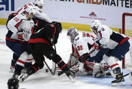 Washington Capitals goaltender Ilya Samsonov (30) and defenseman Dmitry Orlov (9) watch the puck in front of Ottawa Senators center Josh Norris (9) and left wing Brady Tkachuk (7) during the second period of an NHL hockey game in Ottawa, Ontario, on Monday, Oct. 25, 2021. (Justin Tang/The Canadian Press via AP)