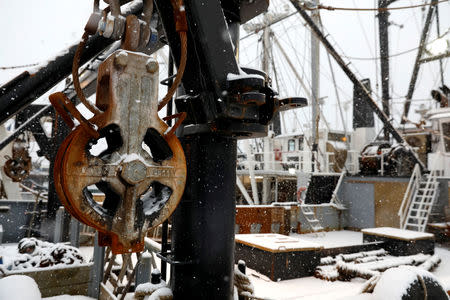 Snow covered fishing boats are seen in New Bedford, Massachusetts, U.S., December 14, 2017. Picture taken December 14, 2017. REUTERS/Shannon Stapleton