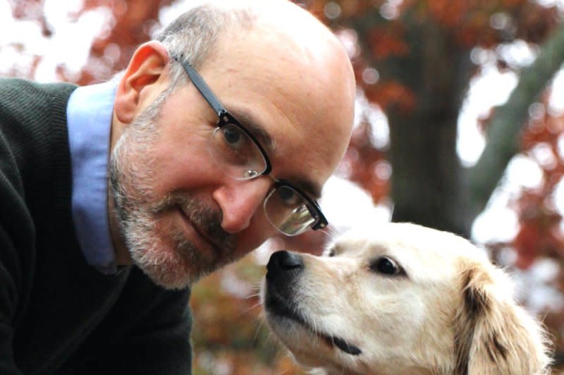 Daniel Promislow, shown with his late dog, Frisbee, is a professor in the Department of Laboratory Medicine &amp Pathology and the Department of Biology at the University of Washington in Seattle and principal investigator of the Dog Aging Project. Photo by Tammi Kaeberlein