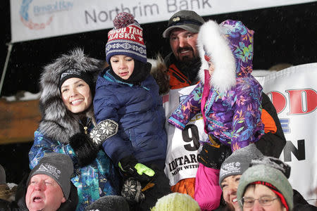 Pete Kaiser of of Bethel, Alaska poses with his wife Bethany, son Ari and daughter Aylee after winning the Iditarod Trail Sled Dog Race after crossing the finish line in Nome, Alaska, U.S. March 13, 2019. REUTERS/Diana Haecker/Nome Nugget